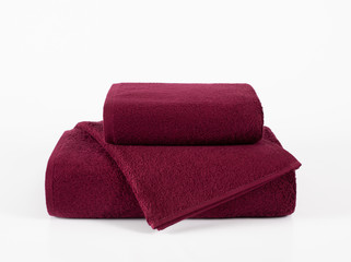 Terry towels stack isolated,maroon towels in stack against the white backdrop
