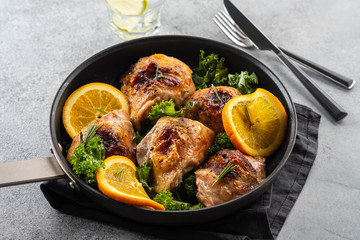 Chicken thighs with orange is a pan.