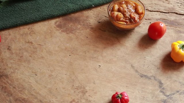 rotation Chole Bhature or Chick pea curry and Fried Puri served in terracotta crockery over wood background.