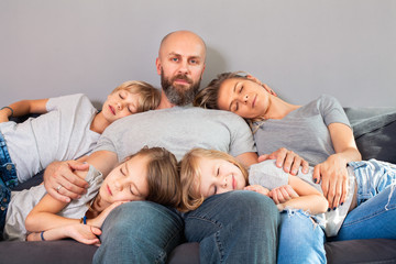 Happy family spending quality time at home together.!Loving family sleeping together,father sitting...