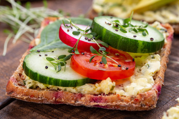 Sandwiches with cream cheese, vegetables and salami.