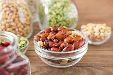 Bowl with beans on wooden table