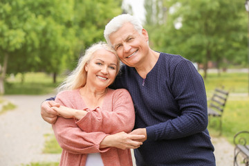 Portrait of happy mature couple in park