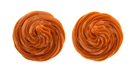 Swirl of caramel cream isolated on white background, top view