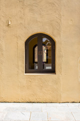 window on clay wall
