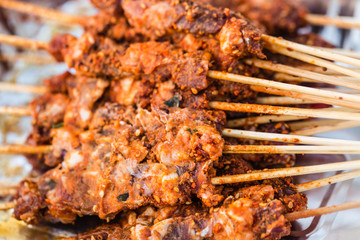 chinese type barbecue raw meat skewers closeup view