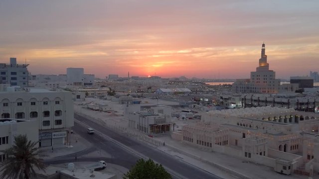 Sunset sky line of Doha Qatar, with views of "Abdulla Bin Zaid Al Mahmoud Islamic Cultural Center" also knowen as "Bin Zaid", filmed in 4k from a high building.