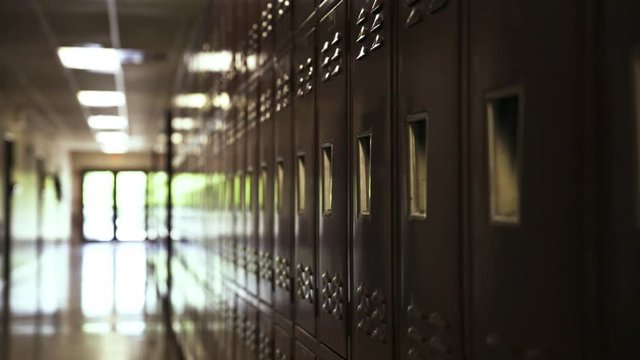 Red high school lockers, narrow hallway.