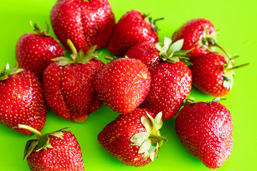Red ripe berry of strawberry on green Matt background