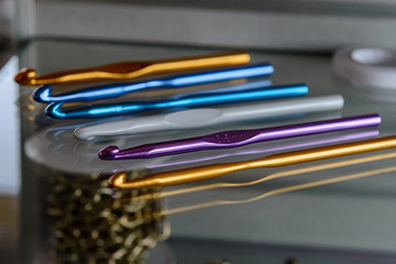 colorful crochet hooks are on the shelf