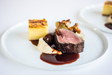 beautiful plate with filet mignon and red wine sauce