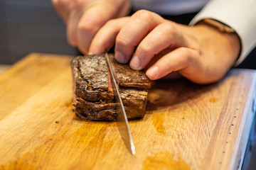 Chef cutting  filet mignon