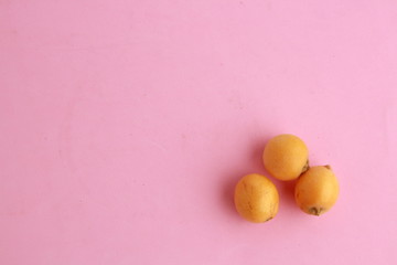 delicious yellow medlar fruit with colorful background