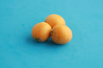 delicious yellow medlar fruit with colorful background