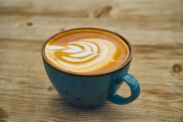 Delicious latte coffee on the wooden table