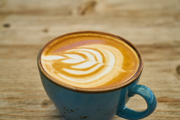 Delicious latte coffee on the wooden table