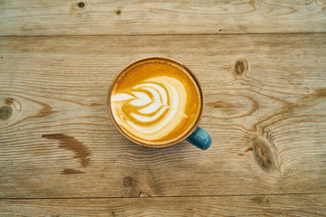 Delicious latte coffee on the wooden table