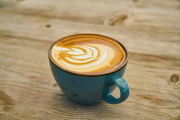 Delicious latte coffee on the wooden table