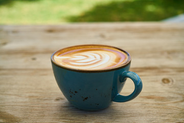 Delicious latte coffee on the wooden table