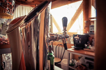 Fototapeta na wymiar Close up of single tap chrome draft beer kegerator tower at bar or pub