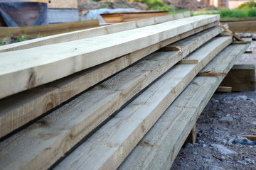 Close-up of a stack of long wooden boards