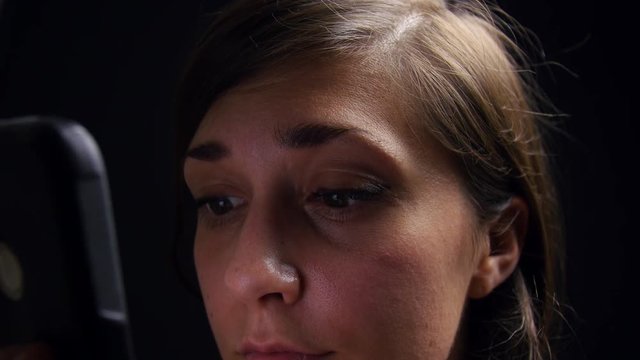 Woman scrolls through social media late at night.