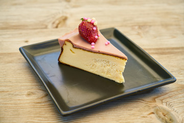 Delicious cheesecake on the wooden table