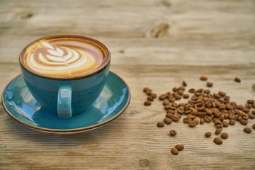 Latte coffee and coffee beans on the wooden table