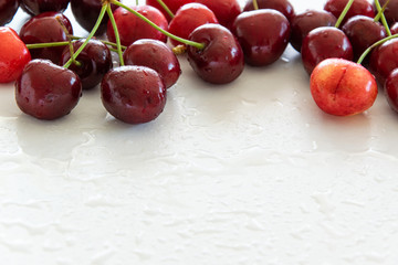 Top view of raw cherries on white background, space for text