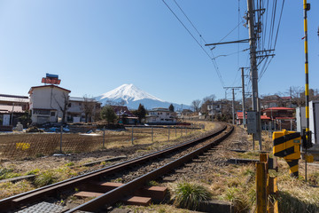 Naklejka premium Train railway pass through Fujiyoshida city and Fuji mountain view