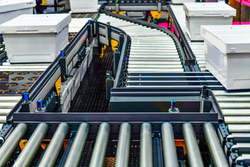 White plastic box on conveyor belt.parcels transportation system concept