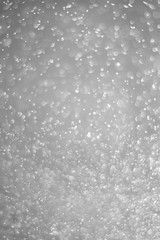 Bokeh background and bubbles reflecting black and white light