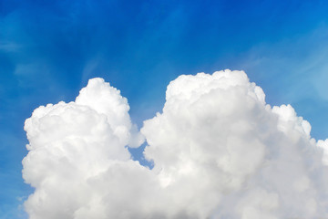 Naklejka na ściany i meble Fluffy white clouds on bright blue sky background