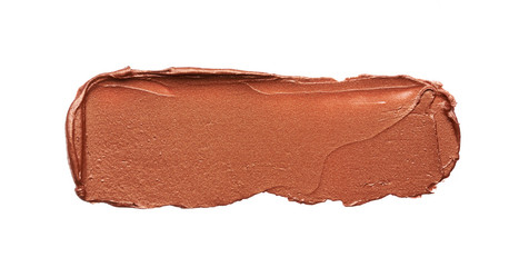Bronze or gold texture of lip gloss or creamy eye shadow