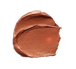 Bronze or gold texture of lip gloss or creamy eye shadow