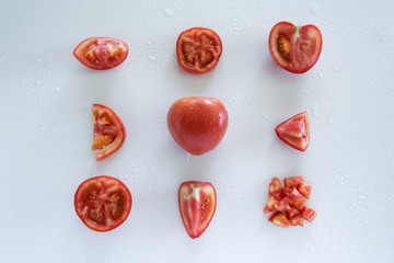 Chopped raw tomatoes on white background, food pattern