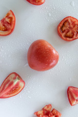 Chopped raw tomatoes on white background, food pattern