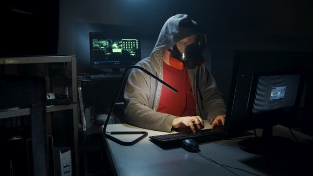Bio-Terrorist types in computer code wearing a gas mask.