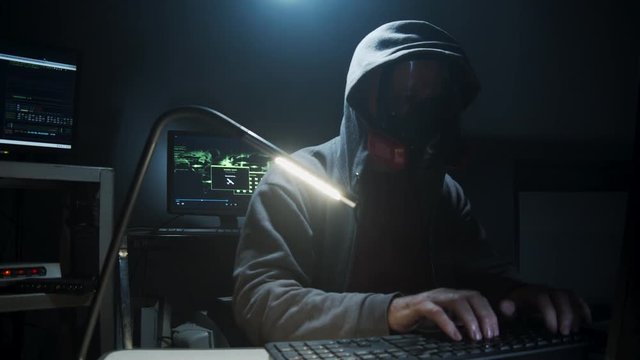 Bio-Terrorist types in computer code wearing a gas mask.