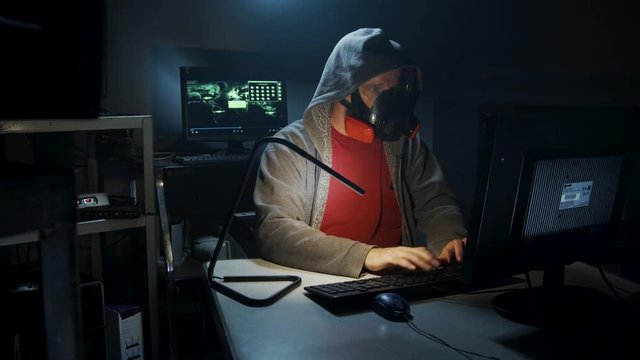 Bio-Terrorist types in computer code wearing a gas mask.