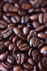 Roasted dark coffee beans background. Close up.