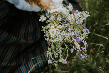 Folk girl in the midsummer making flower