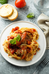 Pasta with meatballs, tomato sauce and basil