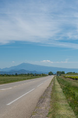 Road heading towards hazy mountains in the distance