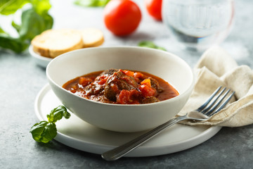 Homemade meatballs with tomato sauce and fresh basil