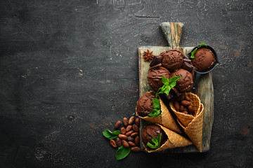 Ice cream with chocolate. Making ice cream on Wooden background. Top view. Free space for your text.