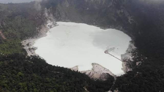 Cinematic aerial view clip of Kawah Putih or White Crater famous of its sulfuric acid lake, located at in Ciwidey, Bandung, Indonesia.