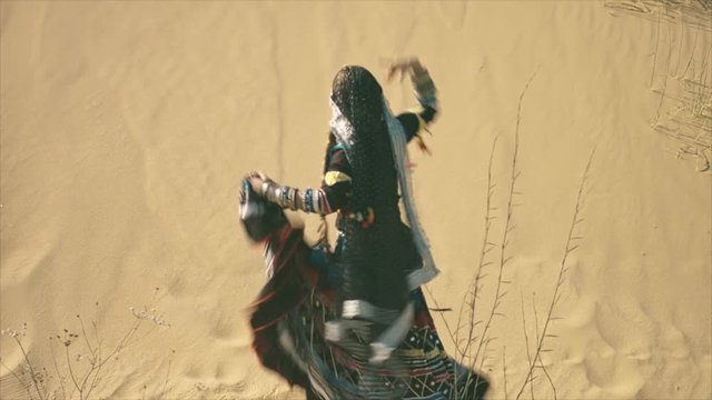 Gypsy woman spinning in the desert