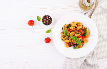 Gnocchi pasta in rustic style.  Italian cuisine. Vegetarian vegetable pasta. Cooking lunch. Gourmet dish. Top view