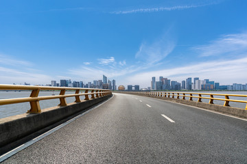 empty raod with city skyline
